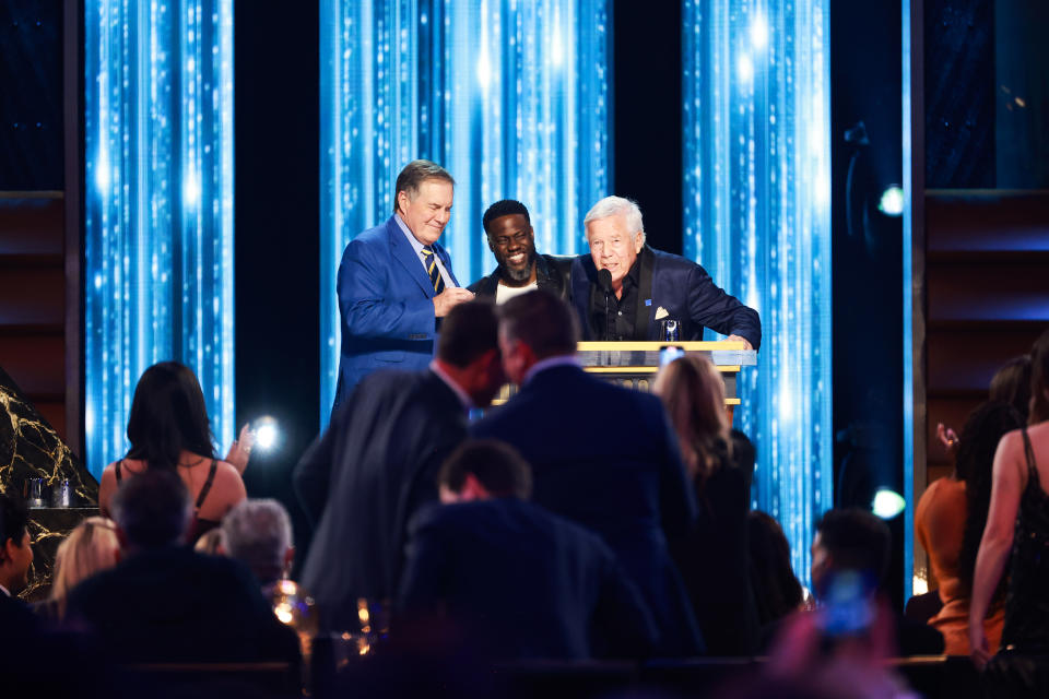 INGLEWOOD, CALIFORNIA - MAY 05: (L-R) Bill Belichick, Kevin Hart and Robert Kraft speak onstage during G.R.O.A.T The Greatest Roast Of All Time: Tom Brady for the Netflix is a Joke Festival at The Kia Forum on May 05, 2024 in Inglewood, California.  (Photo by Matt Winkelmeyer/Getty Images for Netflix)