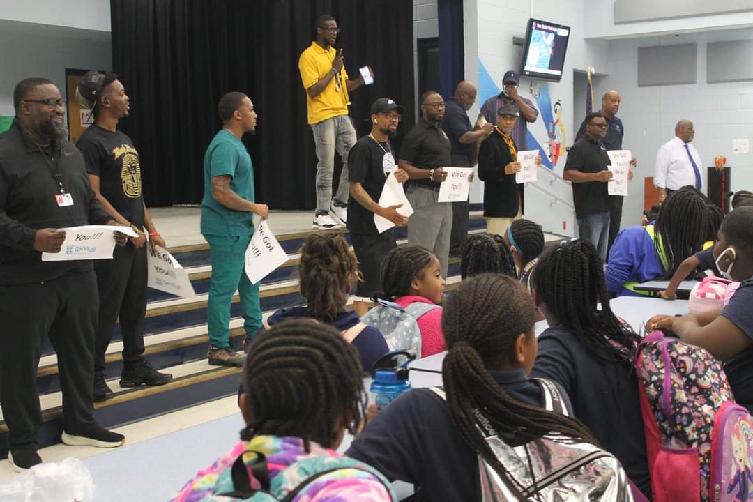 Dads cheer Rawlings Elementary School test takers at an event sponsored by Gainesville For All