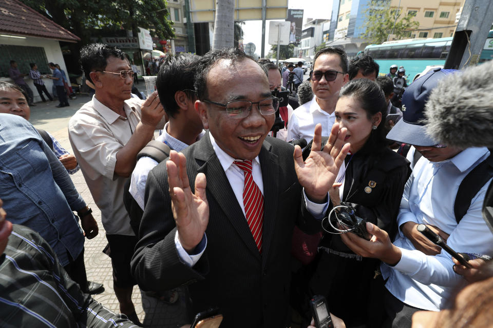 Chan Chen, center, lawyer to Kem Sokha, former leader of now dissolved opposition Cambodia National Rescue Party, talks with the media in front of a court in Phnom Penh, Cambodia Wednesday, Jan. 15, 2020. The trial of the top Cambodian opposition leader charged with treason began Wednesday, more than two years after he was arrested in what is widely seen as a politically motivated prosecution. (AP Photo/Heng Sinith)