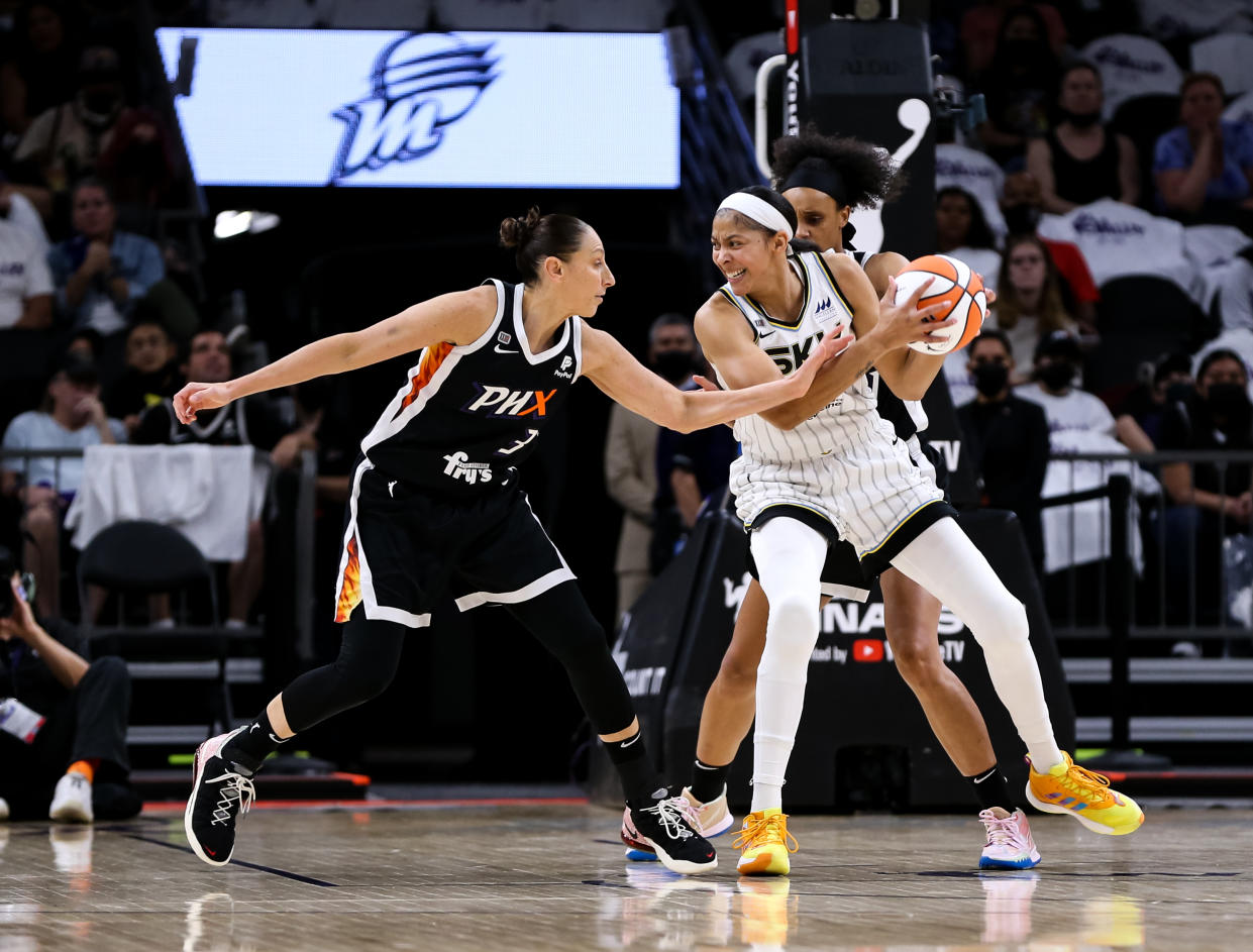 Diana Taurasi reaches in and fouls Candace Parker who is holding the basketball.