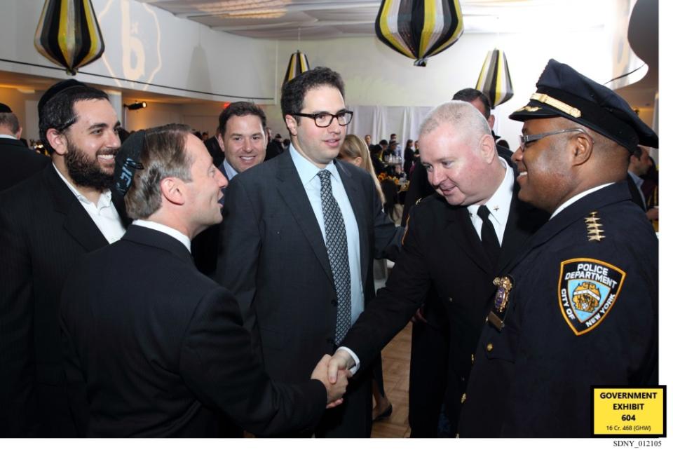 This is Philip Banks (right) when he was a high-ranking cop meeting (second left) Jeremy Reichberg and (center) Jona Rechnitz, both of whom were convicted of a sprawling bribery scheme. Banks got free trips but was not charged with wrongdoing. Evidence photo