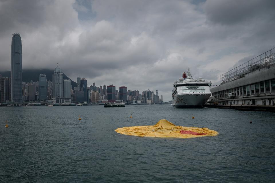 The 16.5-metre-tall inflatable Rubber Duck art installation lies deflated in Hong Kong's Victoria Harbour on May 15, 2013. Organisers said the inflatable Rubber Duck created by Dutch artist Florentijn Hofman had been deflated for scheduled maintenance, but visitors who had made the trip to see it were left disappointed.  AFP PHOTO / Philippe Lopez        (Photo credit should read PHILIPPE LOPEZ/AFP via Getty Images)