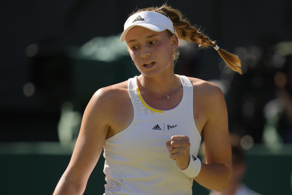 Kazakhstan's Elena Rybakina reacts after winning the first set against Romania's Simona Halep in a women's singles semifinal match on day eleven of the Wimbledon tennis championships in London, Thursday, July 7, 2022. (AP Photo/Kirsty Wigglesworth)