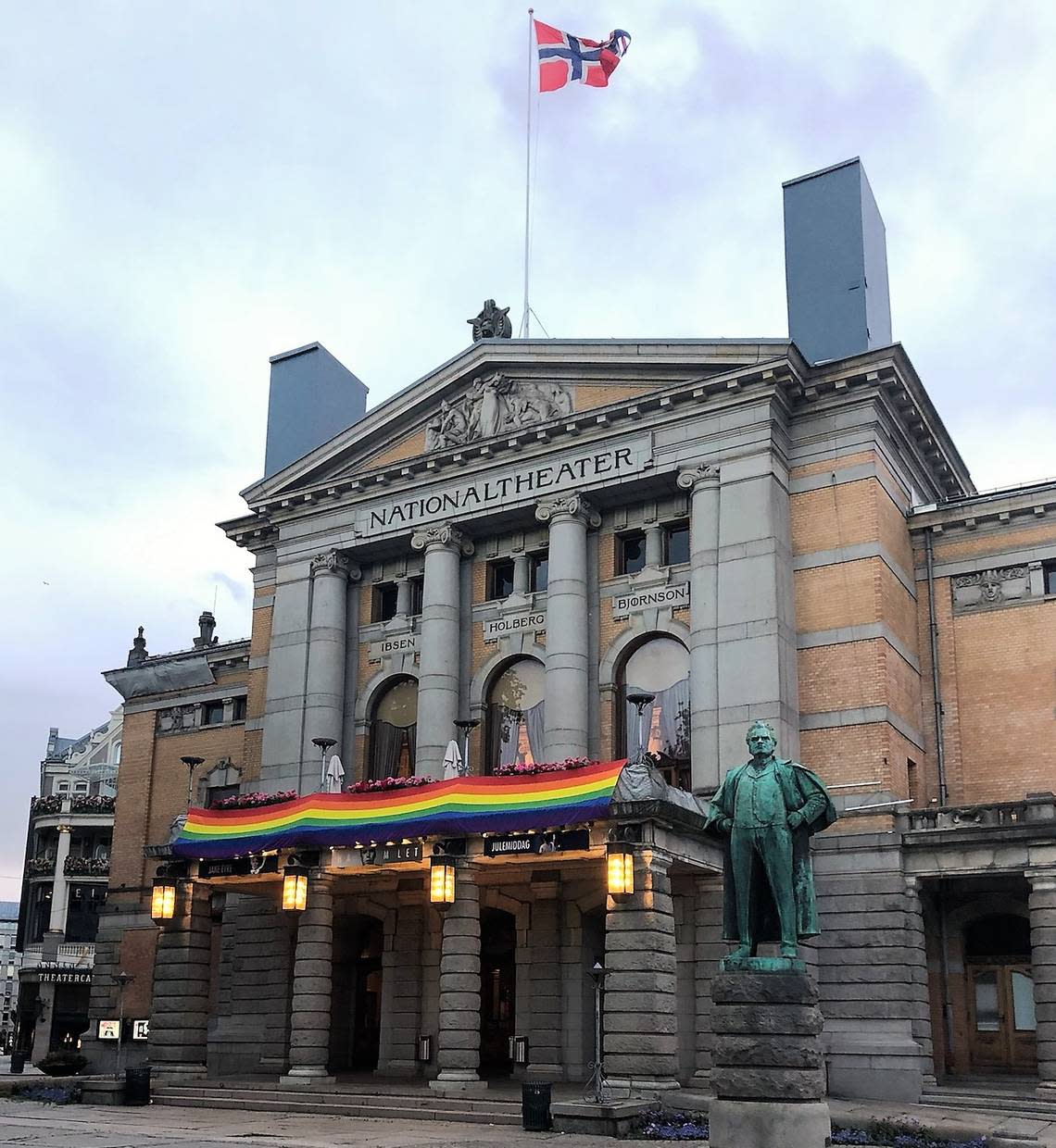 Oslo’s National Theater sporting the rainbow flag of the LGBTQ+ community long after Pride Day, when a gunman went on a rampage at a gay nightclub, killing 2 and injuring 21. Gay unions have been legal in Norway since 1993.