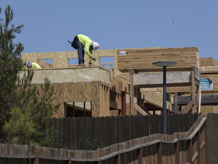 Irvine, CA - August 09: A worker constructs a new home in The Great Park Neighborhoods in Irvine on Monday, Aug. 9, 2021. (Allen J. Schaben / Los Angeles Times)