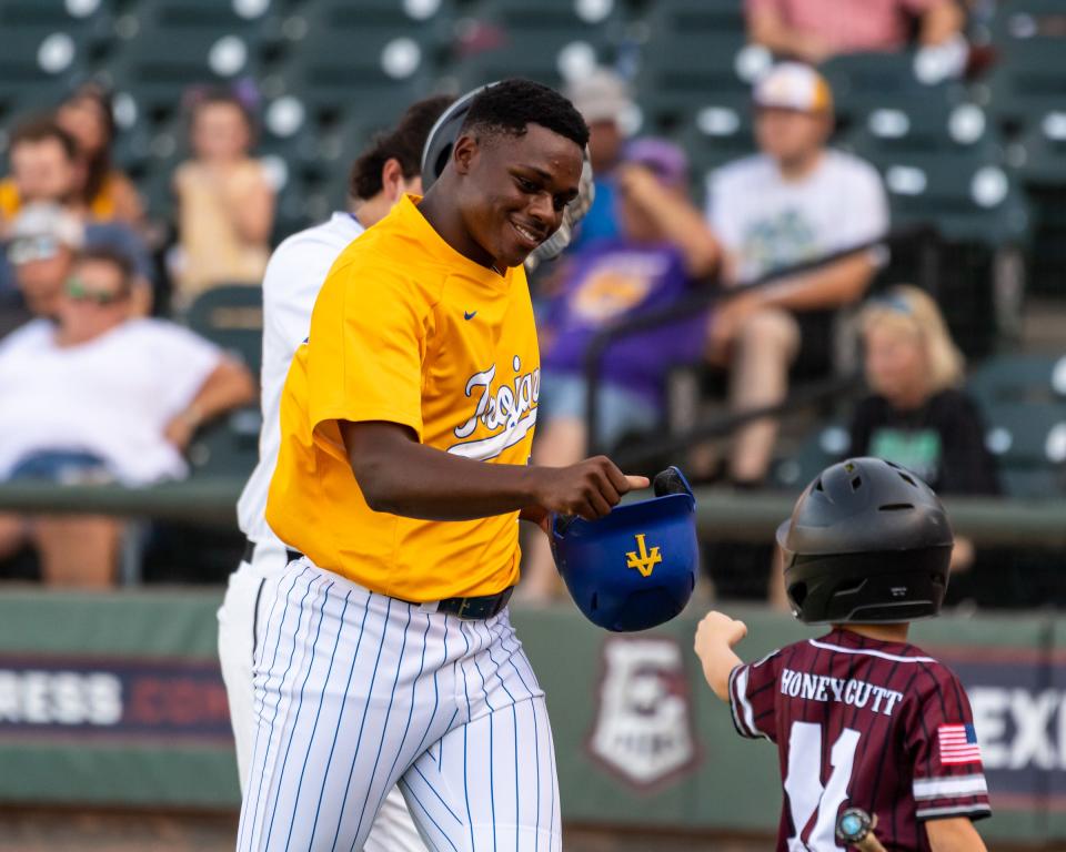 Blake Coleman of Anderson has a fist bump for the ball boy after hitting a home run for the South team during the Austin Area Baseball Coaches Association All-Star game, which was played at Dell Diamond in Round Rock on Sunday. The North and South teams played to a 7-7 tie.