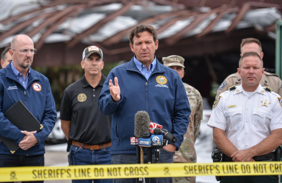 Florida Governor Ron DeSantis speaks to the media from the St. Lucie County Sheriff’s Office on Midway Road on Thursday, Oct. 10, 2024, in Fort Pierce. Governor DeSantis spoke about the State responding to the need of communities affected by Hurricane Milton during the media briefing alongside St. Lucie County Sheriff Kieth Pearson (left) the morning after Hurricane Milton crossed the state at the St. Lucie County Sheriff’s Office on Midway Road in Fort Pierce. The St. Lucie County Sheriff's Office's storage building was struck by a passing tornado damaging the vehicles within during the hurricane.