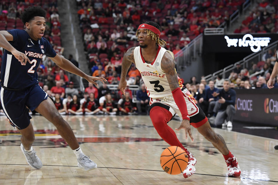 Louisville guard El Ellis (3) drives against Virginia guard Reece Beekman (2) during the second half of an NCAA college basketball game in Louisville, Ky., Wednesday, Feb. 15, 2023. Virginia won 61-58. (AP Photo/Timothy D. Easley)