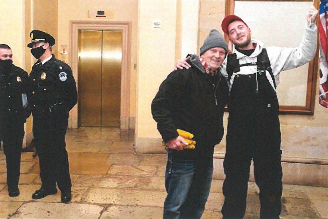 Paul Seymour Sr. and Paul Seymour Jr. (at right, holding flag) inside the U.S. Capitol on Jan. 6, 2021.