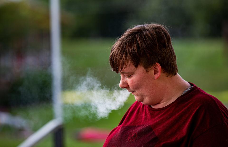 Chelsea Logue smokes a cigarette to calm her nerves while recounting the Dec. 10, 2021, tornado that killed nine people at the Mayfield Consumer Products candle factory. One year later, survivors like Logue still cope with the physical and mental wounds of that night.