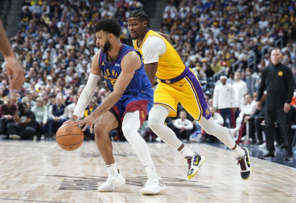 Denver Nuggets guard Jamal Murray, is defended by Lakers forward Cam Reddish.