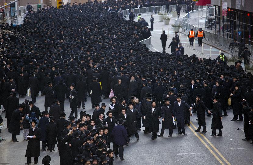 A dance circle is formed after thousands of Orthodox Jews gathered in New York, Sunday, March 9, 2014, on Water Street in lower Manhattan, to pray and protest against the Israeli government's proposal to pass a law that would draft strictly religious citizens into its army. (AP Photo/Craig Ruttle)