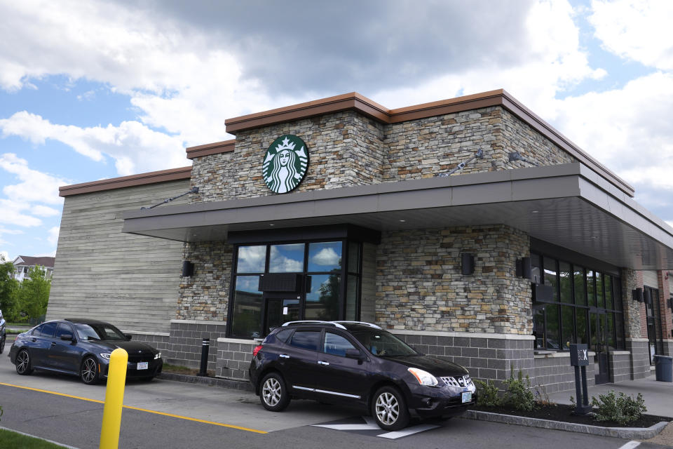 FILE - Cars drive through the pick-up window at a Starbucks store on May 29, 2024, in Salem, N.H. (AP Photo/Charles Krupa, FILE)