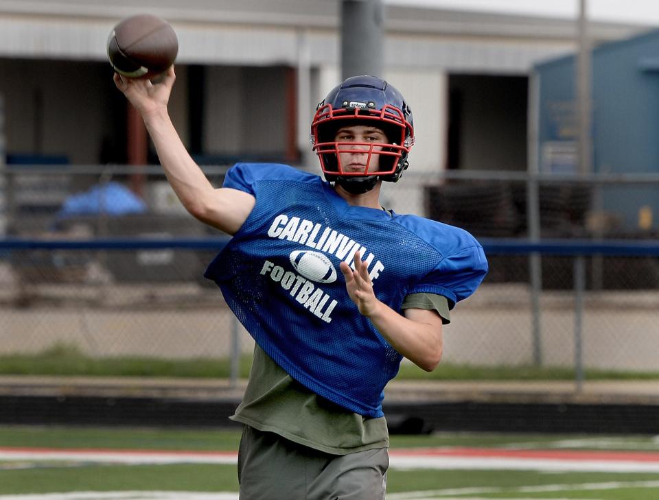 Carlinville High School Quarterback Rex Reels passes the ball during a drill at practice Friday, August 11, 2023.