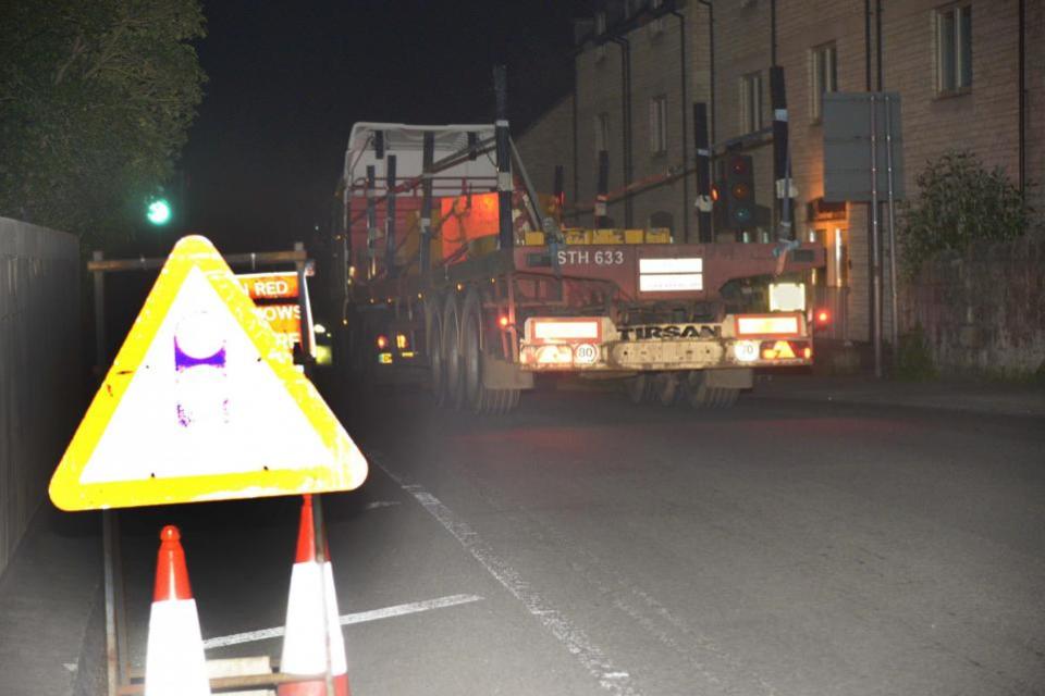 Wiltshire Times: One of the specialist heavy duty lorries brought in for the removal of the road over rail bridge leaves the site after the operation was called off. Photo: Trevor Porter 69863-2