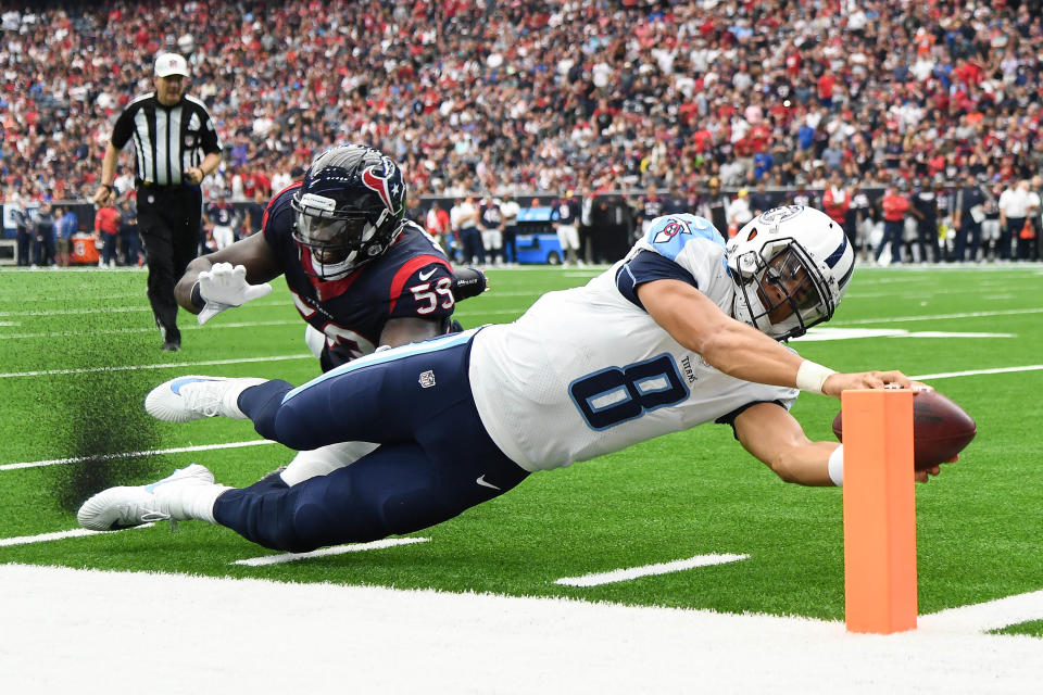 <p>Tennessee Titans quarterback Marcus Mariota (8) scores a touchdown ahead of Houston Texans outside linebacker Whitney Mercilus (59) during the second quarter at NRG Stadium. Mandatory Credit: Shanna Lockwood-USA TODAY Sports </p>