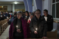 Community members gather and hold a vigil for the six people killed in a plane crash, in Fort Smith, Northwest Territories, on Wednesday, Jan. 24, 2024. (Jason Franson/The Canadian Press via AP)