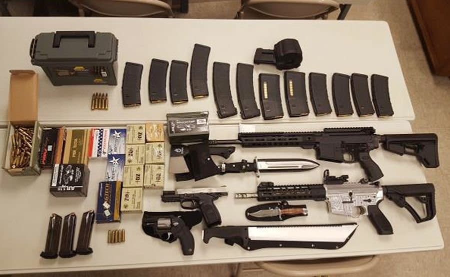 A cache of weapons is displayed in Johnson City Tenn. Federal agents are trying to determine why Scott Edmisten, a man pulled over for speeding in Tennessee, was carrying a cache of weapons including two submachine guns and hundreds of rounds of ammunition.