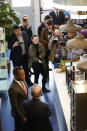 Democratic presidential candidate, former New York Mayor Michael Bloomberg, front back to camera, chats with Richmond mayor Levar Stoney, front left, under the watchful eye of the media at a coffee shop in Richmond, Va., Tuesday, Jan. 7, 2020. (AP Photo/Steve Helber)