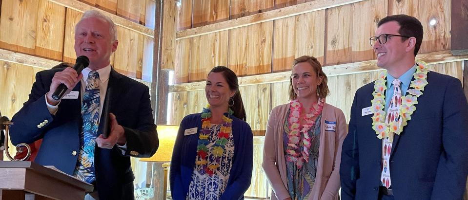 Charlevoix County Community Foundation President Chip Hanson (left) speaks while accepting the East Jordan Area Chamber of Commerce's Angel Award on behalf of the foundation.