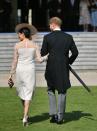 <p>She accessorised with a large-brimmed hat from Philip Treacy tilted to the side, with her hair styled in a low bun. Photo: Getty </p>