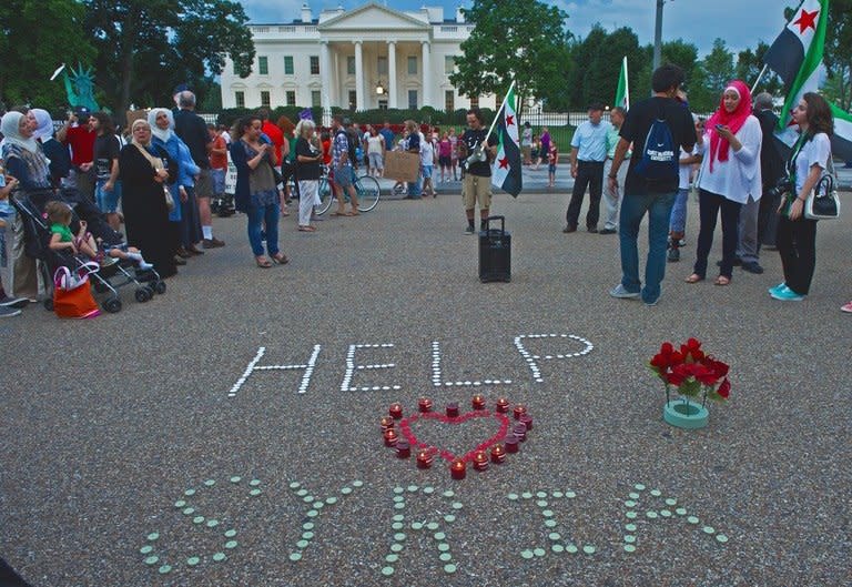 Demonstrators calling for help from US President Obama on the Syrian revolution protest in front of the White House on August 21, 2013, in Washington, DC. Syria on Thursday came under intense pressure to allow UN weapons inspectors to visit the site of an alleged chemical weapons attack near Damascus which the opposition says left hundreds dead and provoked revulsion around the world