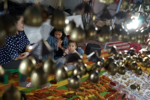 Vendors wait for customers at the main tourist market in Luang Prabang, northern Laos