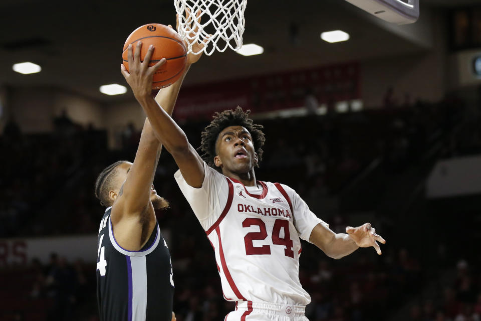 Oklahoma guard Jamal Bieniemy (24) shoots in front of Kansas State forward Levi Stockard III, left, in the second half of an NCAA college basketball game in Norman, Okla., Saturday, Jan. 4, 2020. (AP Photo/Sue Ogrocki)