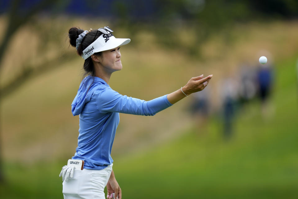 Grace Kim, of Australia, tosses a ball to her caddie on the third hole during the third round of the Women's PGA Championship golf tournament, Saturday, June 24, 2023, in Springfield, N.J. (AP Photo/Seth Wenig)