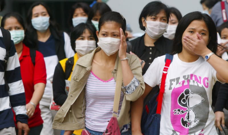 FILE PHOTO: Foreign domestic workers wear masks to protect themselves from Severe Acute Respiratory Syndrome (SARS), in Hong Kong