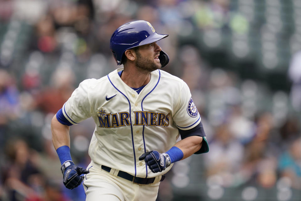 Seattle Mariners' Mitch Haniger watches the path of his solo home run against the Arizona Diamondbacks in the fourth inning of a baseball game Sunday, Sept. 12, 2021, in Seattle. (AP Photo/Elaine Thompson)