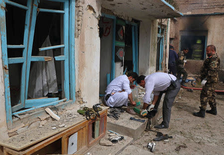 Afghan officials inspect the site of a suicide bomb attack outside a Shi'ite mosque in Herat, Afghanistan March 25, 2018. REUTERS/Mohammad Shoib