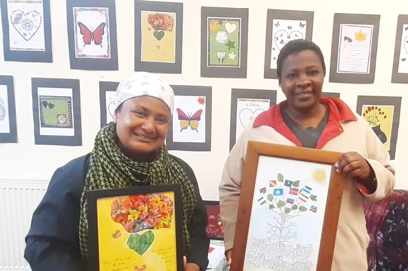 Zine participants Shani (L) and Adolfine holding the images they created for the it at the zine launch at Asylum Link Merseyside on June 27 (Image: Patrick Graham Liverpool ECHO)