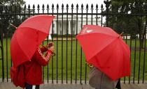 With few options open to tourists due to the federal government shutdown, a couple brave relentless rain to see the White House in Washington October 10, 2013. Senate Democratic leaders and House Republican leaders are scheduled to meet separately with U.S. President Barack Obama to discuss the budget crisis and a looming debt deadline in Washington. (REUTERS/Kevin Lamarque)