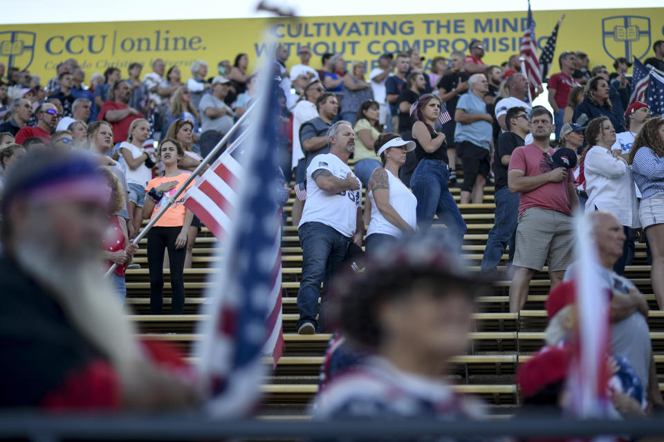 MORRISON, CO - SEPTEMBER 1: People stand for the national anthem during an anti-mask gathering at Bandimere Speedway on Tuesday, September 1, 2020. Thousands of people showed up to speak out against masks required by the state that were enacted to help curb the spread of coronavirus. The event was highlighted by speeches on patriotism, Jesus Christ and stories of family members who served the country. (Photo by AAron Ontiveroz/MediaNews Group/The Denver Post via Getty Images)