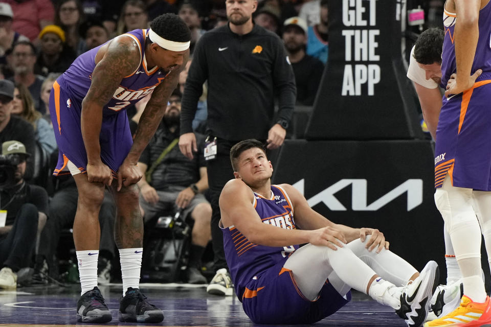 Phoenix Suns guard Grayson Allen, center, reacts to guard Bradley Beal, left, after getting elbowed during the second half of an NBA basketball game against the Oklahoma City Thunder, Sunday, March 3, 2024, in Phoenix. (AP Photo/Rick Scuteri)