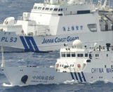 A Japan Coast Guard vessel sails along with Chinese surveillance ship Haijian No. 66, foreground, near disputed islands called Senkaku in Japan and Diaoyu in China, in the East China Sea, on Monday, Sept. 24, 2012. (AP Photo/Kyodo News) JAPAN OUT, MANDATORY CREDIT, NO LICENSING IN CHINA, HONG KONG, JAPAN, SOUTH KOREA AND FRANCE