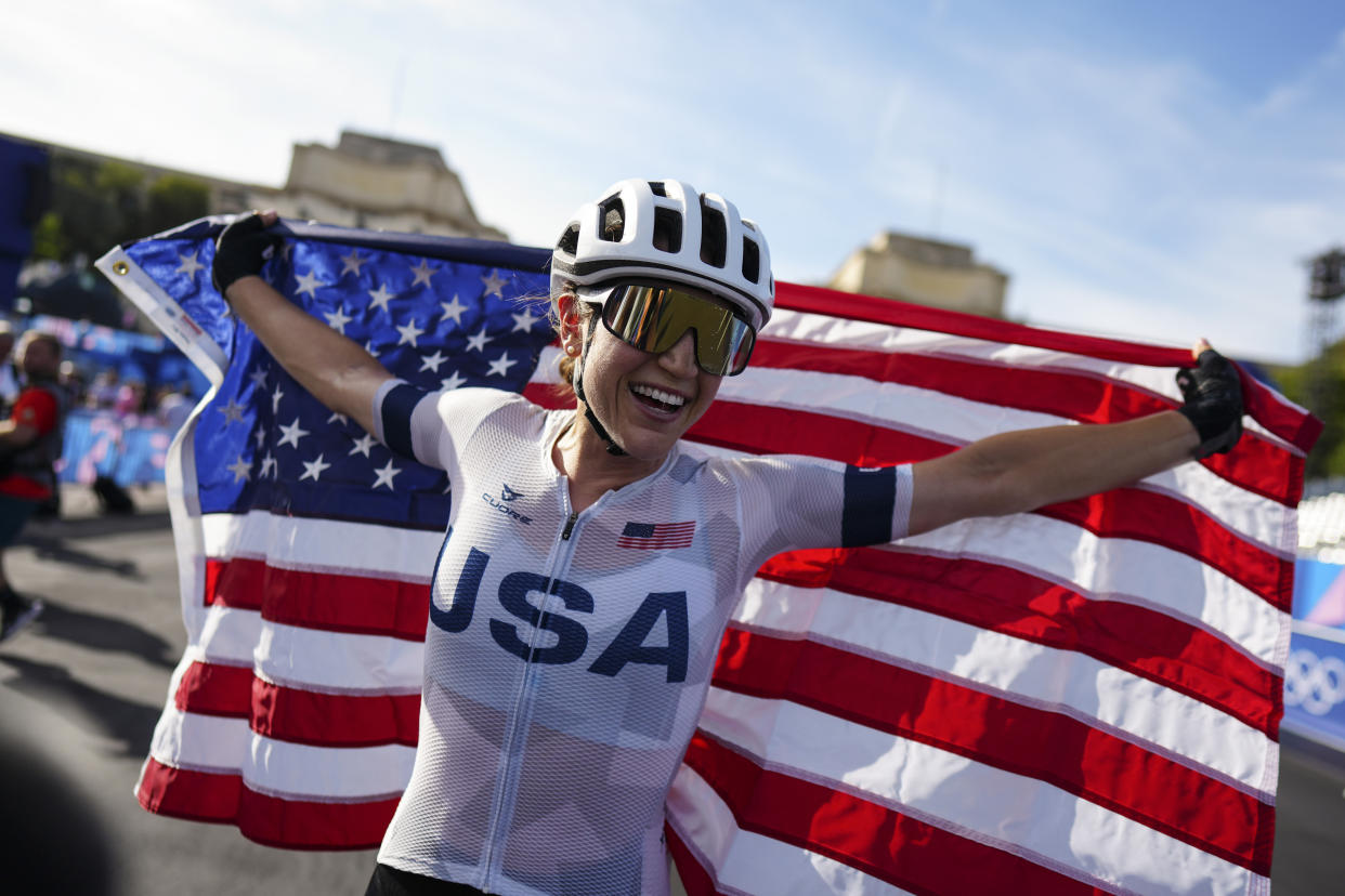 Kristen Faulkner, of the United States, celebrates winning the women's road cycling event, at the 2024 Summer Olympics, Sunday, Aug. 4, 2024, in Paris, France. (AP Photo/Thibault Camus)