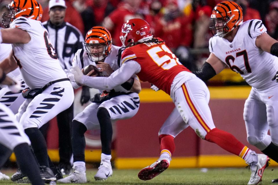 Cincinnati Bengals quarterback Joe Burrow (9) is sacked by Kansas City Chiefs defensive end Mike Danna (51) in the first quarter of the AFC championship NFL game between the Cincinnati Bengals and the Kansas City Chiefs, Sunday, Jan. 29, 2023, at Arrowhead Stadium in Kansas City, Mo. The Chiefs led 13-6 at halftime.