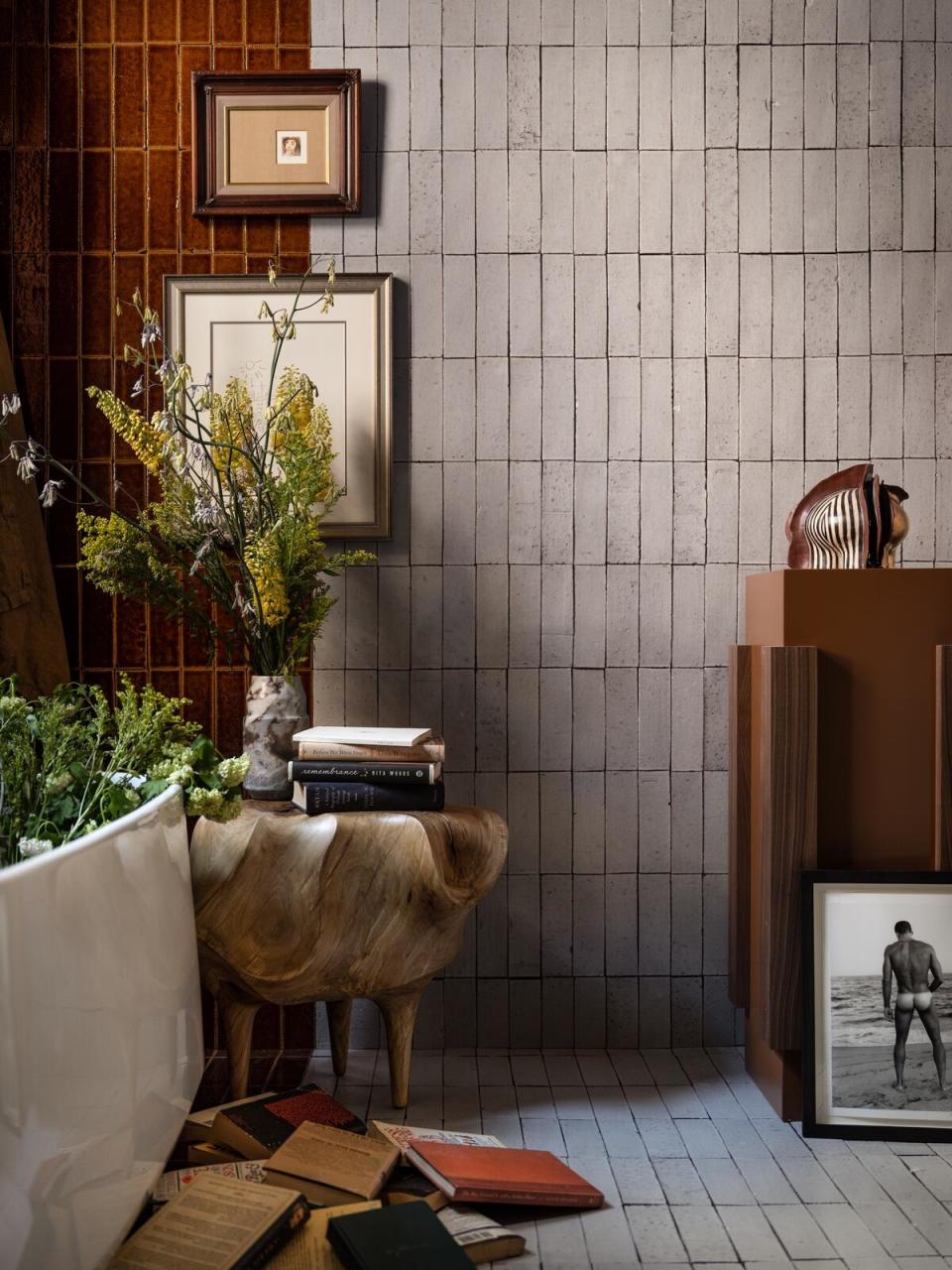 Mahogany-hued tiles and organic wood accents add warmth to a bathroom designed by Ahmad AbouZanat