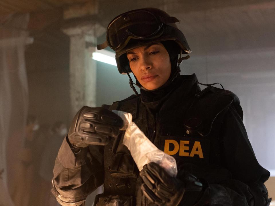 A DEA officer, played by Rosario Dawson, holds a bag of drugs on Hulu's "Dopesick."