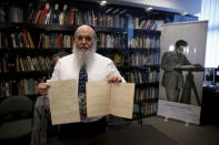 Roni Gross, curator of the Hebrew University's Albert Einstein Archive, displays original documents related to Albert Einstein's hypothesis of the existence of gravitational waves during a news conference in Jerusalem February 11, 2016. REUTERS/Ronen Zvulun