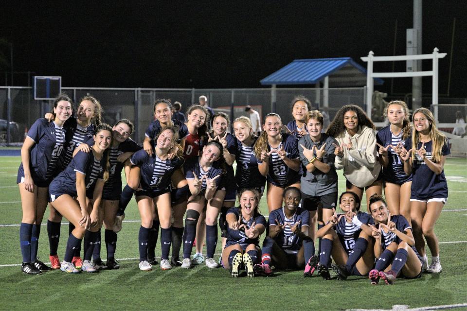 The American Heritage-Delray girls soccer team poses for a celebratory photo after winning the state semifinals against McKeel Academy, 3-1 on Feb. 17, 2023.