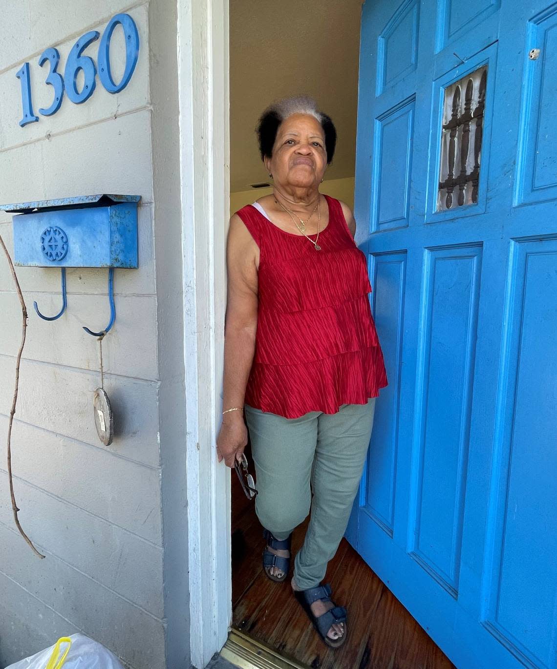 Barbara Fuller, a River Park resident, stands in the doorway of her home after Hurricane Ian on Saturday, Oct. 1, 2022. Her home flooded during a storm surge caused by Hurricane Ian on Wednesday, Sept. 28.