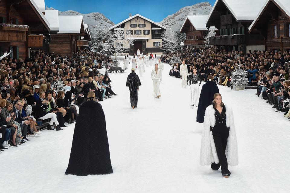 <p>Karl Lagerfeld famously said many things, and one of them was that he did not like funerals. “I do not want anyone to come to mine. Do what you want with the ashes,” he told Vanessa Gregoriadis in a 2002 profile in <em><a rel="nofollow noopener" href="https://nymag.com/nymag/features/15746/index4.html" target="_blank" data-ylk="slk:New York;elm:context_link;itc:0;sec:content-canvas" class="link ">New York</a></em>. “Send them down the garbage chute.”</p><p>If guests at Chanel’s fall 2019 show needed any further indication that this presentation, Lagerfeld’s final collection after <a rel="nofollow noopener" href="https://www.elle.com/fashion/a26403702/karl-lagerfeld-dies-at-85/" target="_blank" data-ylk="slk:his passing on February 19;elm:context_link;itc:0;sec:content-canvas" class="link ">his passing on February 19</a>, wouldn’t mark the occasion in any remarkable way, a simple drawing of Lagerfeld and Coco Chanel on each seat read “and the beat goes on.” There was a minute of silence to mark the occasion and that was that.</p><p>So in many ways it was just another Chanel collection with another fantastical set: this time an Alpine ski town complete with piles of snow and smoking chimneys and après-ski clothes. There were chunky knit sweaters and skirts worn with shearling boots; loose, long menswear inspired coats in houndstooth and herringbone prints wrapped at the waist over pleat-front pants that took inspiration from men’s suiting; more classic tweed looks gave way to brightly colored puffers and zip front body suits. A series of feathery white dresses closed the show, delicate as snowflakes modeled by Adut Akech, Kaia Gerber, and Penelope Cruz, who smiled down the runway holding a white rose.</p><p>Though nothing about the show invited an emotional outpouring, the finale brought many to tears, including the models and many in the front row. The entire Grand Palais rose to its feet for a standing ovation that lasted for minutes.</p>