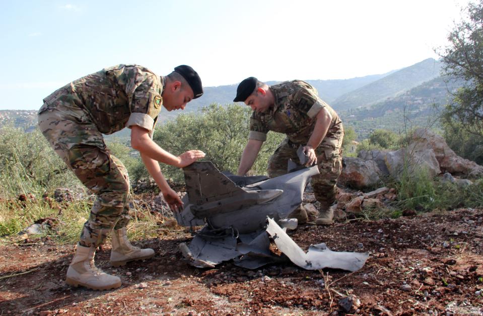 <p>Lebanese soldiers inspect remains of a surface to air missile that landed in the southern Lebanese village of Hebarieh, early on May 10, 2018. Dozens of rockets were fired from Syria on the Israeli-occupied Golan overnight, a war monitor said, without confirming Israeli reports they were fired by Iranian forces. “After the first Israeli bombardment on the town of Baath, dozens of rockets were launched from Quneitra and the southwest of the adjacent Damascus countryside on the occupied part of the Golan Heights,” the Syrian Observatory for Human Rights said. Israel said it was in retaliation for Iranian rocket fire from the Quneitra area that it launched missile strikes on Iranian military infrastructure in Syria. (Photo: Ali Dia/ FP/Getty Images) </p>