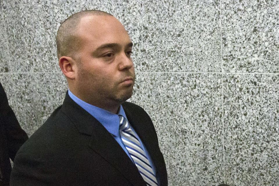 FILE - In this Nov. 5, 2014, file photo, New York City police officer David Afanador leaves state court in New York following his arraignment. Afanador, 39, was arrested Thursday, June 25, 2020, on charges of strangulation and attempted strangulation over an altercation last weekend on the Rockaway Beach boardwalk. The confrontation on the boardwalk came after weeks of protests following the death of George Floyd in Minnesota. (AP Photo/Bebeto Matthews, File)