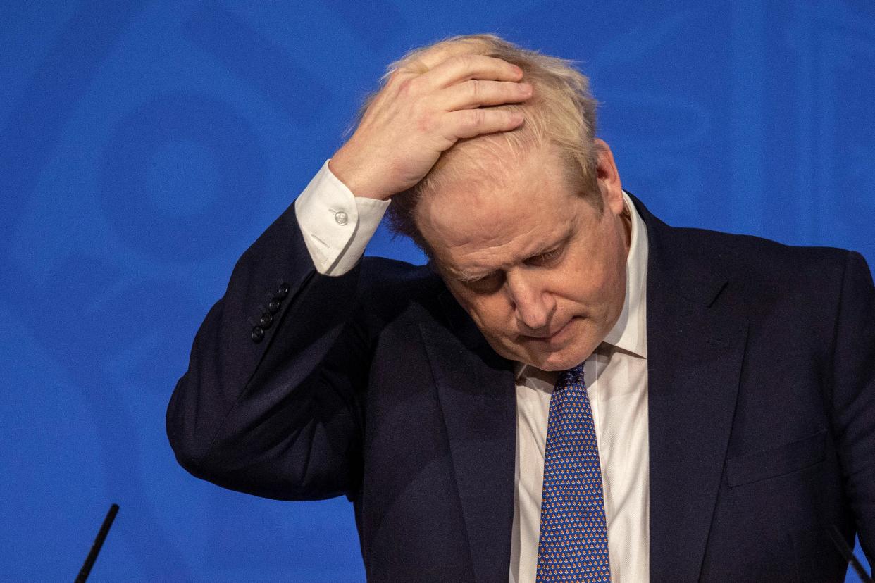 Britain's Prime Minister Boris Johnson reacts during a virtual press conference to update the nation on the status of the Covid-19 pandemic, in the Downing Street briefing room in central London on January 4, 2022. - British hospitals have switched to a 