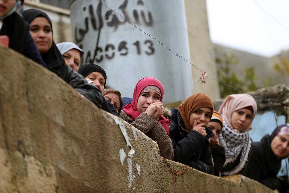 Relatives of Palestinian Ahmed al-Remawi mourn during his funeral