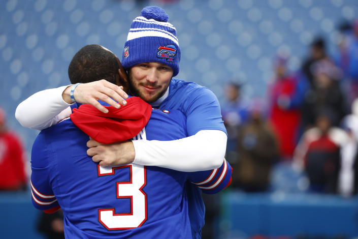 Buffalo Bills quarterback Josh Allen, center, hugs a teammate during practice while players wear the number 3 in support of safety Damar Hamlin during practice before an NFL football game against the New England Patriots, Sunday, Jan. 8, 2023, in Orchard Park, N.Y. Hamlin remains hospitalized after suffering a catastrophic on-field collapse in the team's previous game against the Cincinnati Bengals. (AP Photo/Jeffrey T. Barnes)